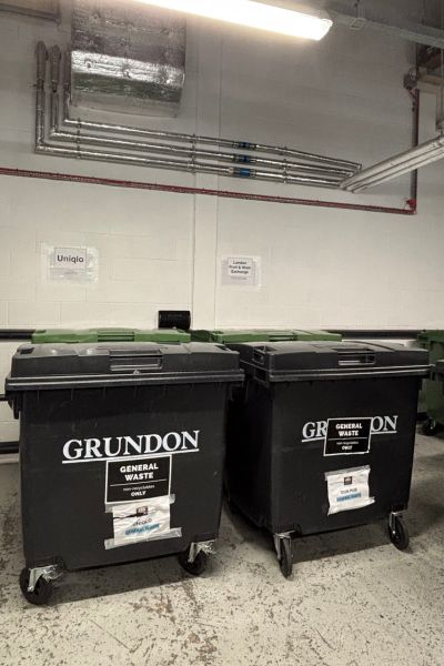 Waste containers in a shared bin store
