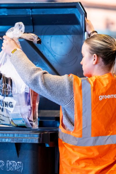 An operative weighing waste at a GreenrWeigh station
