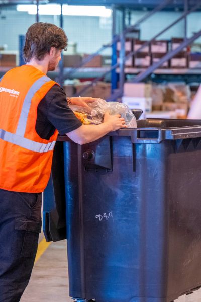 Recycling bins in a busy back-of-house corridor